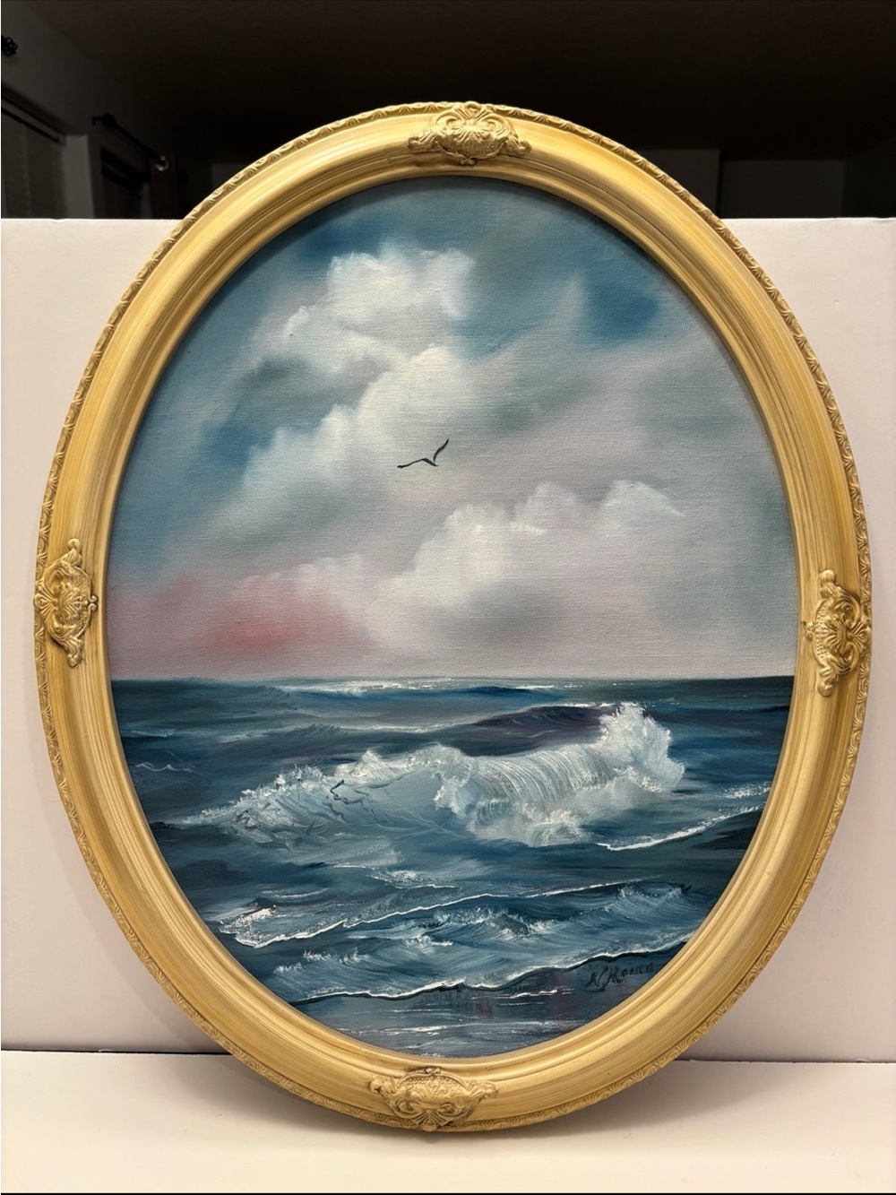 Oval painting of ocean waves signed by N.Moore